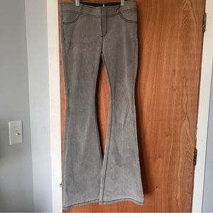 Free people low-rise gray flare jeans with black stitching.
